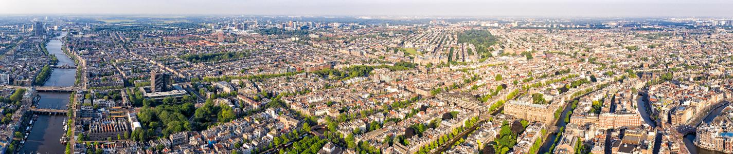 Amsterdam, Netherlands. Panorama of the city from the air. River Amstel and gateways. Summer